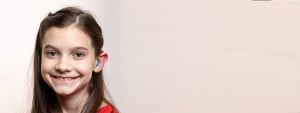 Girl with hearing aids smiling